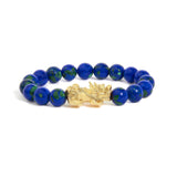 Pulsera con cuentas de azurita y dije de dragón en oro amarillo de 18K