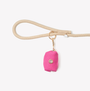 Magenta poop bag holder clipped to a leash handle