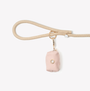 Baby Pink poop bag holder clipped to a leash handle