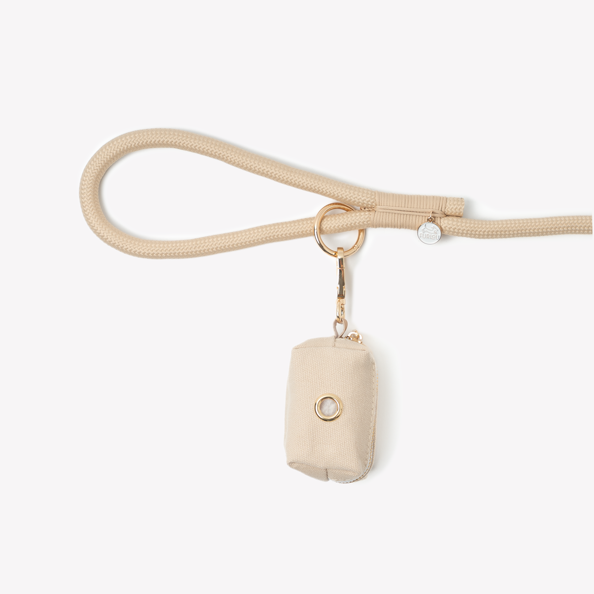 Tan poop bag holder clipped to a leash handle