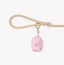 Pink poop bag holder clipped to a leash handle