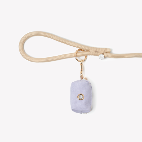 Lavender poop bag holder clipped to a leash handle