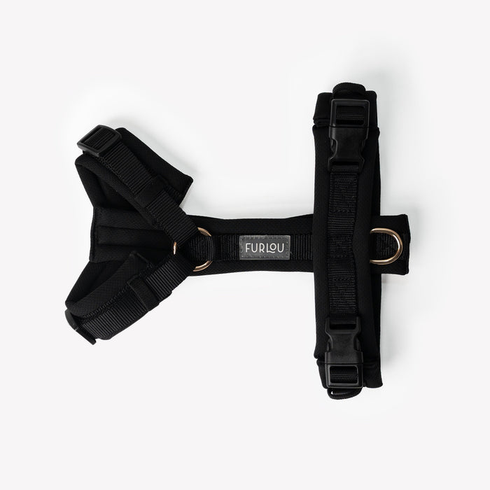 Black comfort dog harness laid flat