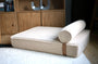 Modern Day boucle dog bed with its bolster on a white rug