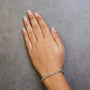 Pulsera tenis de eslabones en S con Miracle Plate redondo y diamantes de 1/10 ct. p.t. en plata de ley, foto 7