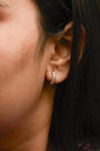 1/10 Ct. T.W. Diamond and Rope Twist Huggy Hoop Earrings in 10K Yellow Gold, photo 3