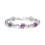 Pulsera tenis de cruz con diamantes naturales redondos de 1/10 ct. p.t. y amatista ovalada de 7x5mm en plata de ley