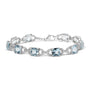 Pulsera tenis con topacio azul talla cojín de 7x7 mm y diamantes talla redonda de 1/20 ct. p.t. en plata de ley, foto 1