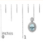 Aretes de botón colgantes con detalle de diamante, topacio azul ovalado y halo de cuentas en plata de ley, foto 5