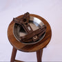 Brown comfort harness on a wooden stool beside a dog bowl