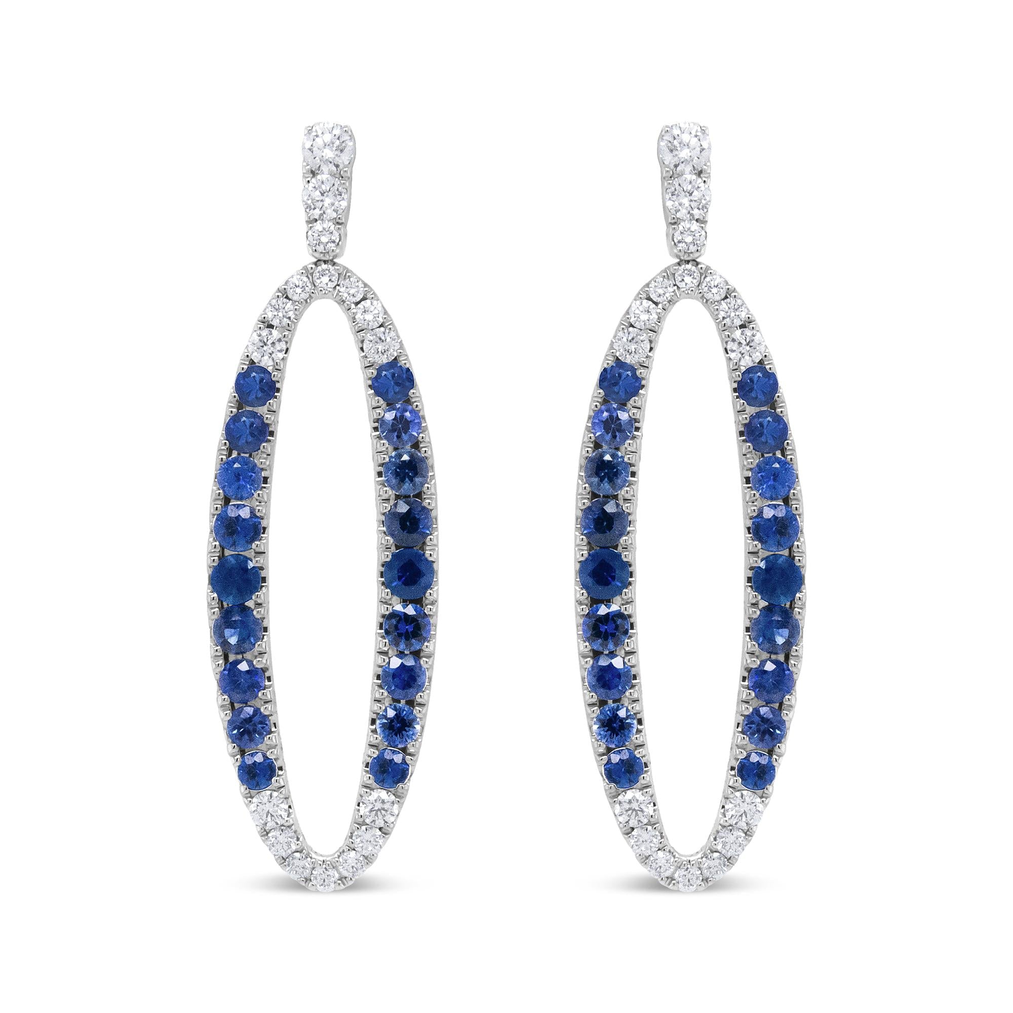 Aretes colgantes ovalados calados con diamantes de 1.11 ct. p.t. y zafiros azules en oro blanco de 18K, color F-G, claridad VS1-VS2, foto 1