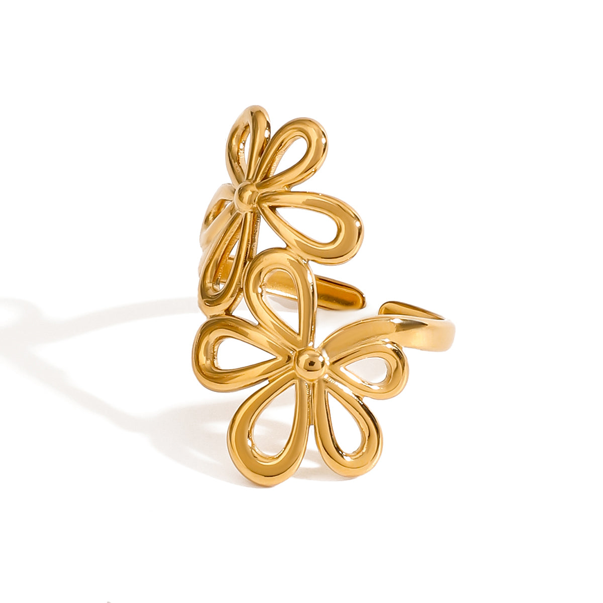 Gold tone cuff ring, 18K gold plated, featuring double flower outlines with smooth rounded petals and mirror high-polish finish in an open, dimensional silhouette.