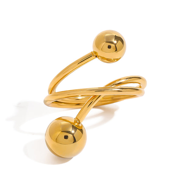 Gold tone cuff ring, 18K gold plated, in a wrap design with crossing smooth bands and two polished sphere ends, open construction, no stones visible.