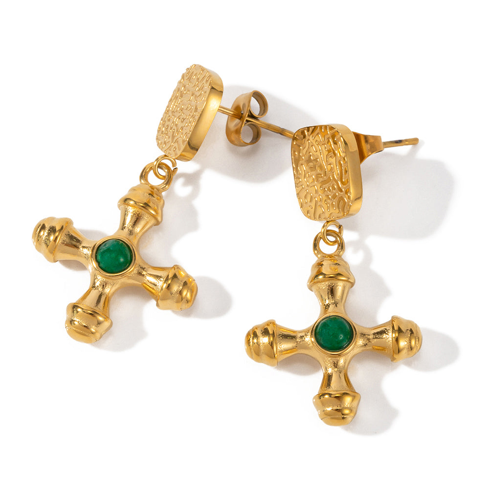 Gold tone drop earrings, 18K gold plated, with textured rectangular studs and dangling cross pendants featuring an emerald green round center stone, no other stones visible, post visible.