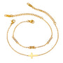 Gold tone bracelet set, 18K gold plated, with two fine cable chains featuring a cross charm and a slim bar with clear crystal accents, lobster clasps and extender chains visible.