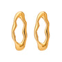 Gold tone hoop earrings, 18K gold plated, shaped as organic open-center oval hoops with a molten sculpted profile, smooth rounded edges, and mirror high-polish finish, no stones visible.