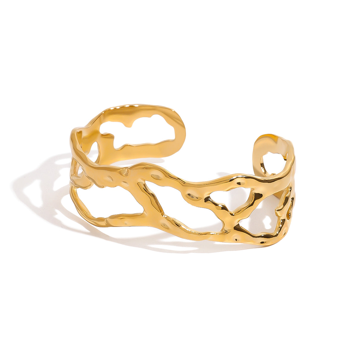 Gold tone cuff bracelet, 18K gold plated, with an organic openwork cutout pattern and smooth rounded edges in a mirror high-polish finish, open cuff construction, no stones visible.