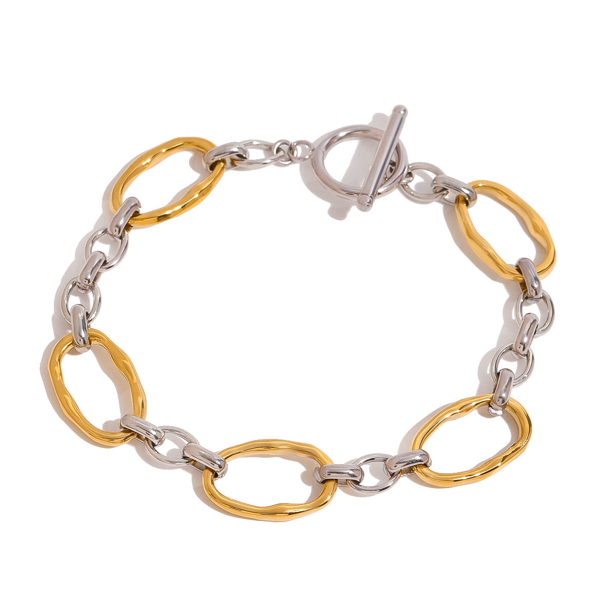 Two tone gold tone and silver tone chain bracelet, 18K gold plated, with oversized oval links and smaller connector links, toggle clasp visible, no stones visible.