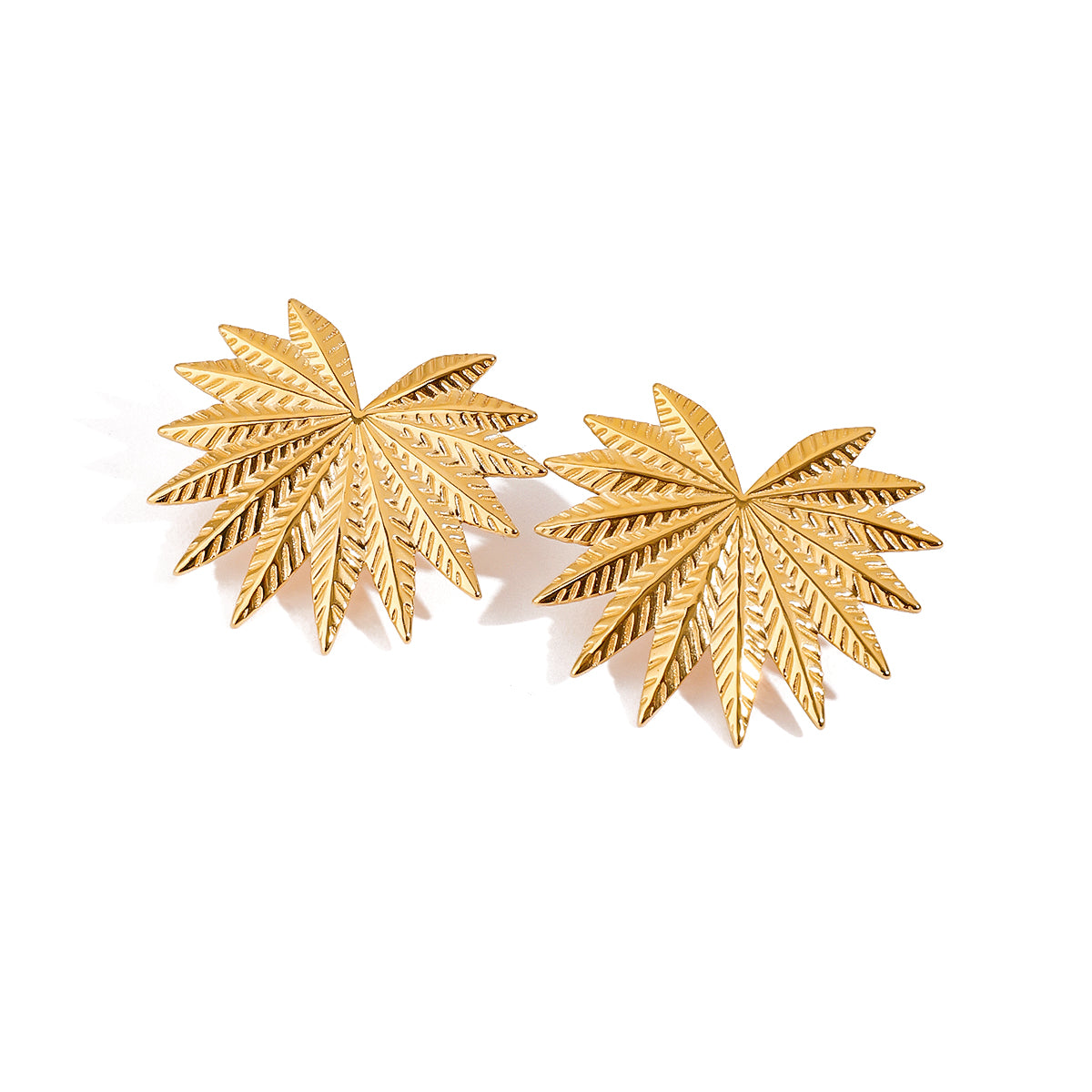 Gold tone stud earrings, 18K gold plated, shaped as palm burst motifs with multiple etched leaf fronds and a high-polish finish, no stones visible, post-back not visible.