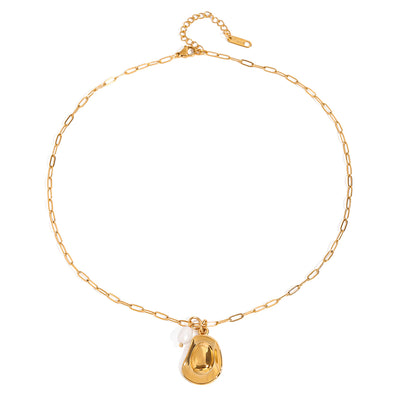 Gold tone charm necklace, 18K gold plated, on an elongated link chain with a polished pebble-shaped charm and a single pearl drop, lobster clasp and extender visible, no other stones visible.