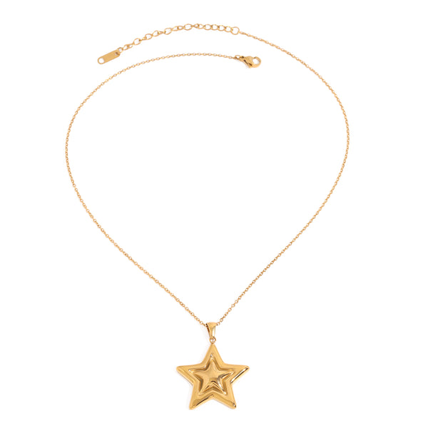 Gold tone pendant necklace, 18K gold plated, on a fine cable chain with a puffed sculpted star pendant in a high-polish finish, lobster clasp and extender visible, no stones visible.