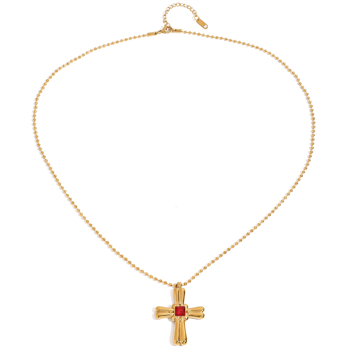 Gold tone pendant necklace, 18K gold plated, on a fine beaded chain with a rounded sculpted cross pendant and red square center stone, lobster clasp and extender visible.