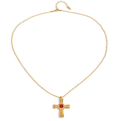 Gold tone pendant necklace, 18K gold plated, on a fine beaded chain with a rounded sculpted cross pendant and red square center stone, lobster clasp and extender visible.