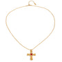 Gold tone pendant necklace, 18K gold plated, on a fine beaded chain with a rounded sculpted cross pendant and red square center stone, lobster clasp and extender visible.