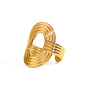 Gold tone statement ring, 18K gold plated, with an oversized oval crest and layered ribbed ridges in a mirror high-polish finish, open cuff construction, and no stones visible.