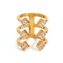 Gold tone statement ring, 18K gold plated, with a wide ladder silhouette of three open bands tipped with square bezel-set clear stones, no other stones visible.