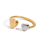 Two tone gold tone and silver tone cuff ring, 18K gold plated, with two smooth heart-shaped ends in a mirror high-polish finish, open cuff construction, no stones visible.