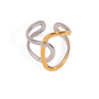 Two tone gold tone and silver tone cuff ring, 18K gold plated, shaped as intertwined crossover loops with a mirror high-polish finish, smooth rounded edges, open construction, and no stones visible.