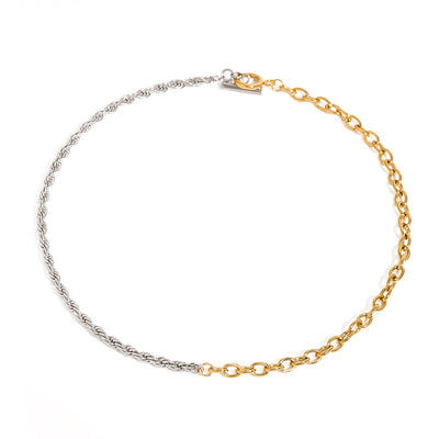Two tone gold tone and silver tone chain necklace, 18K gold plated, with one side of twisted rope links and one side of glossy oval links, toggle clasp visible, no stones visible.