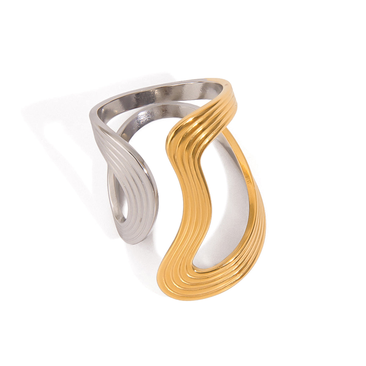 Two tone gold tone and silver tone cuff ring, 18K gold plated, shaped as a flowing wave with ribbed ridges and a high-polish finish, no stones visible.